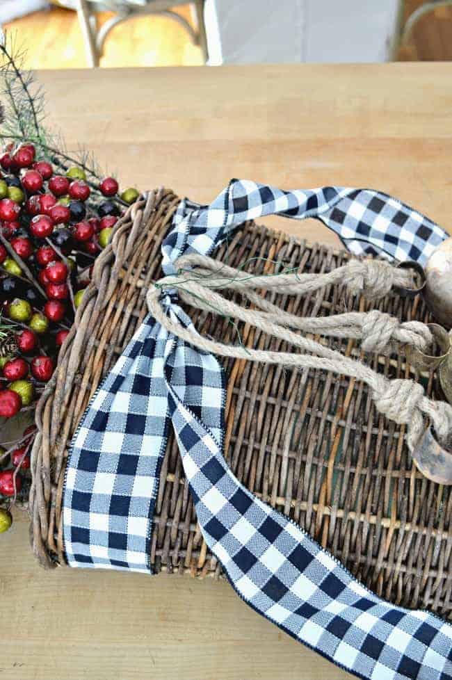 Create a simple DIY Christmas front door basket with bells to add holiday color to your front door.