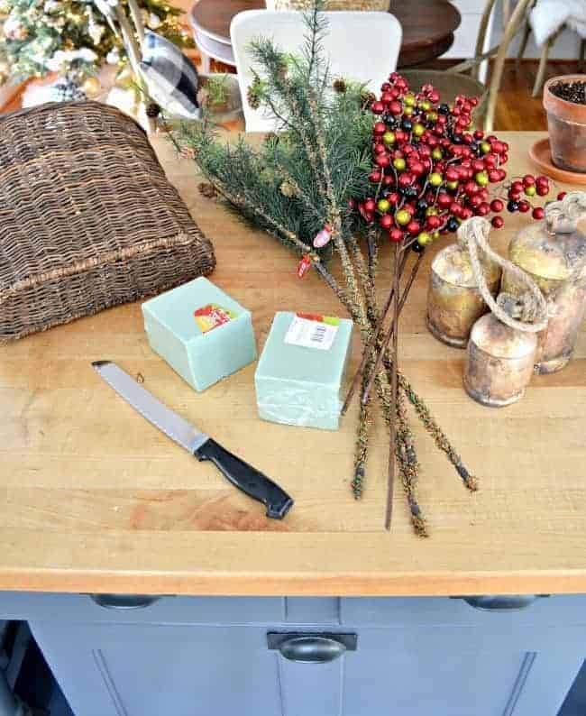 Create this simple DIY Christmas front door basket to add holiday color to your front door.