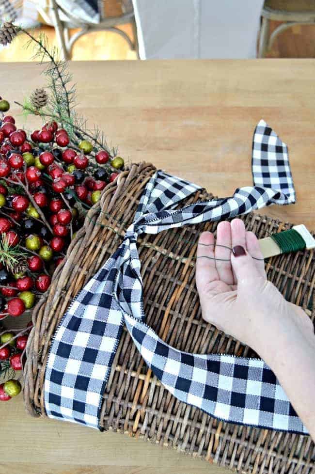 How to make a simple DIY Christmas front door basket to add holiday color to your front door.