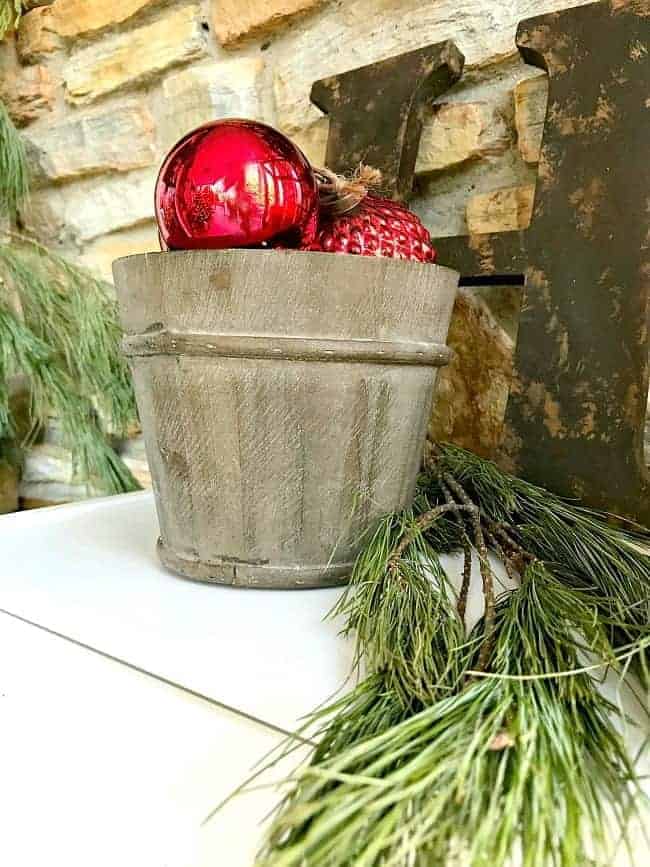  bucket of red ornaments on front porch