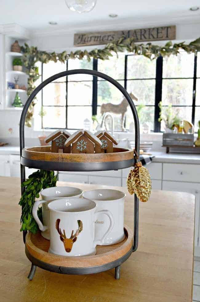 How to create a cozy cottage Christmas kitchen by using farmhouse touches like a two tiered tray and gingerbread houses.