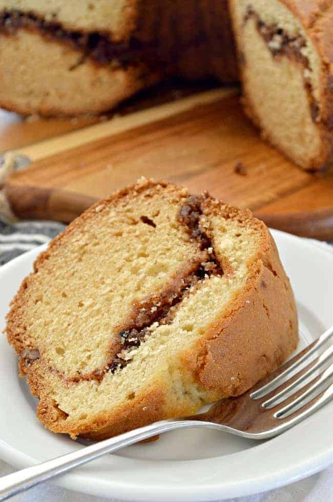 slice of sour cream coffee cake on plate with fork 