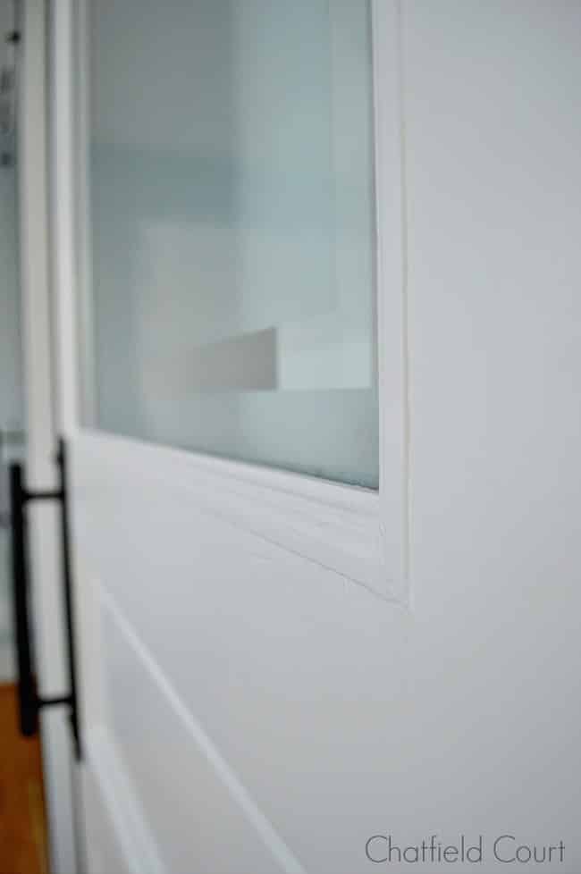 frosted glass door on barn door for powder room