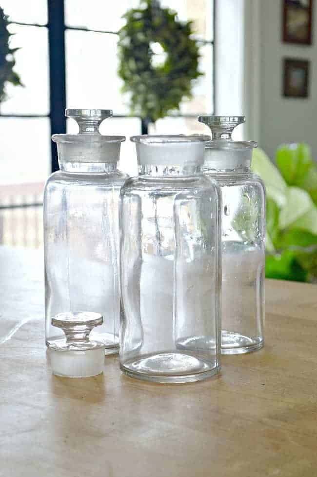 3 thrifted glass bottles with glass lids