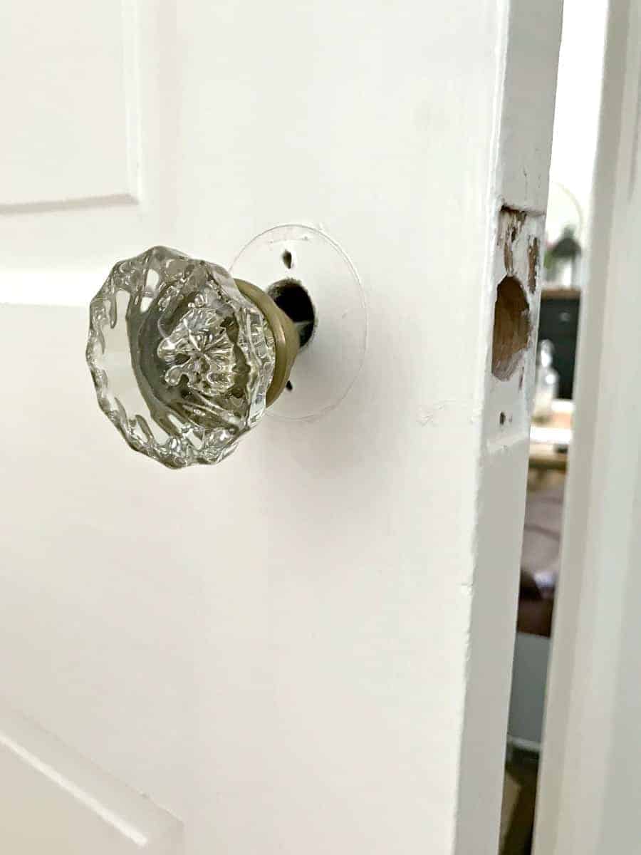 vintage glass door knob hanging loosely on door