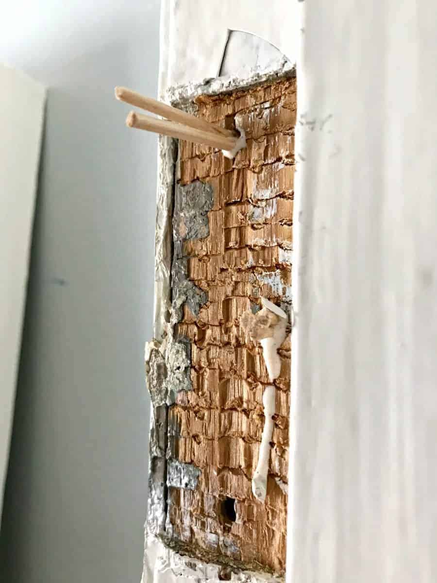 toothpicks and wood glue in holes where door hinges are installed