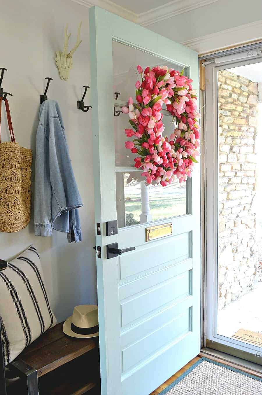pink tulip wreath on blue front door