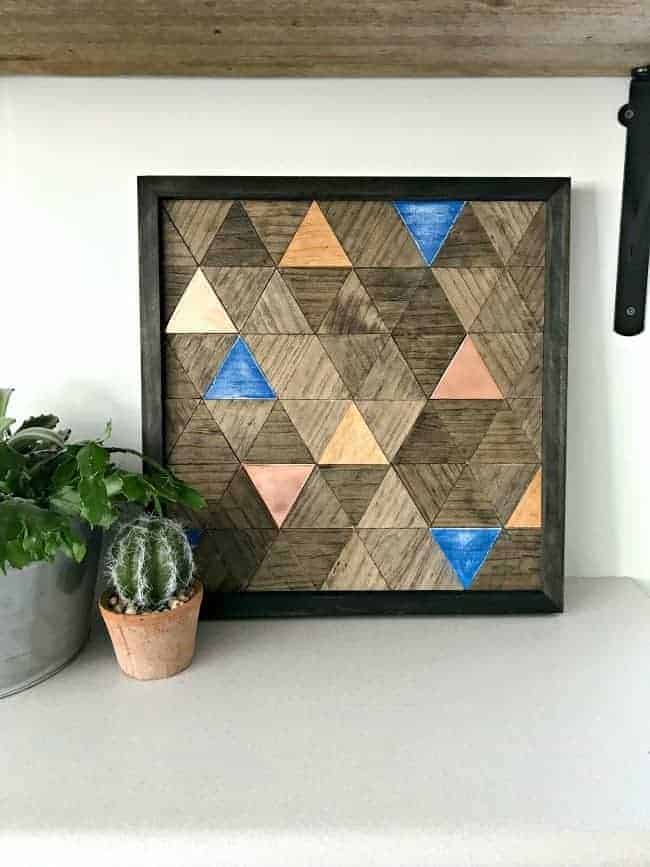 wood wall art with potted succulents