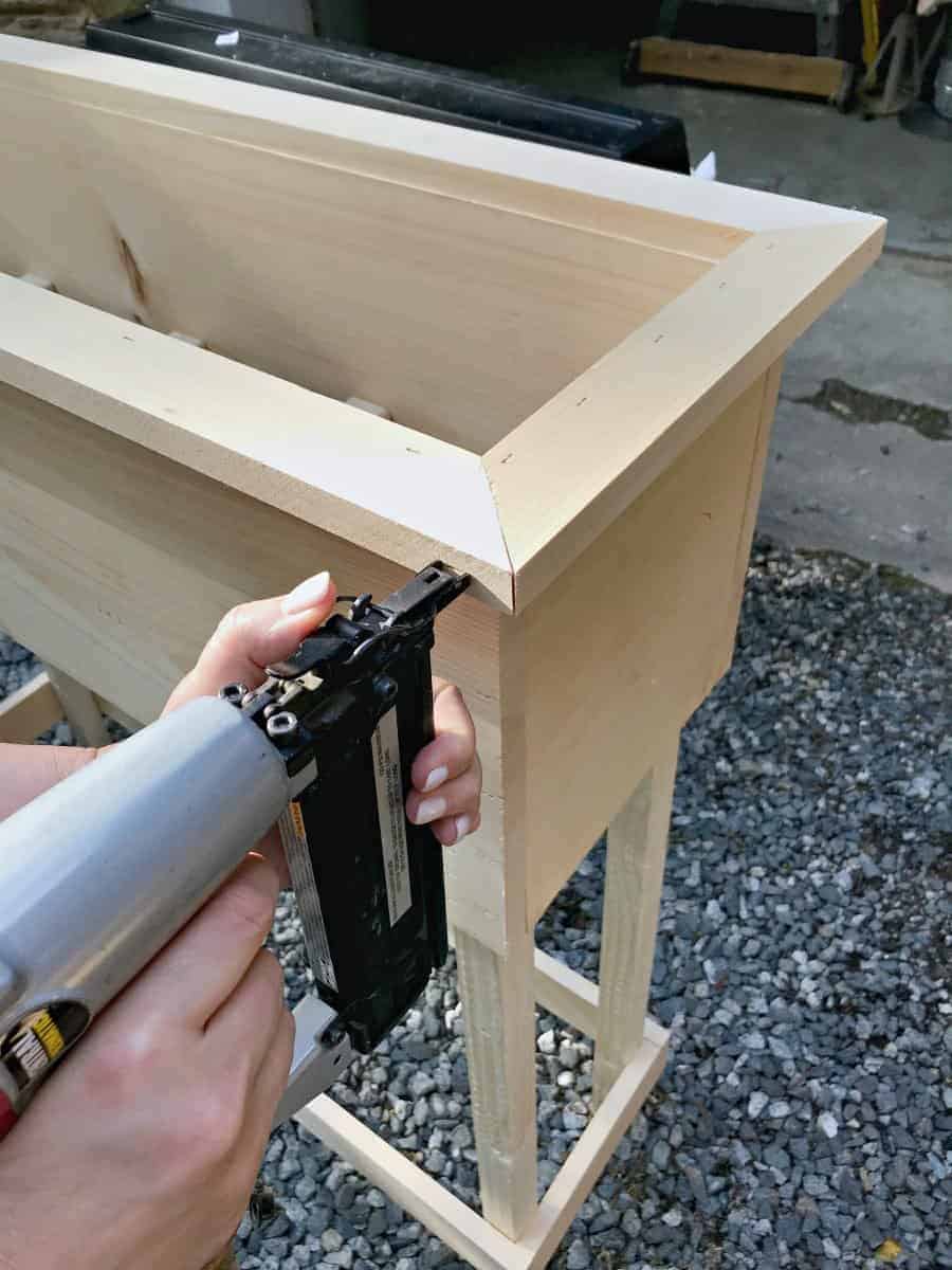 stapling wood on a DIY planter