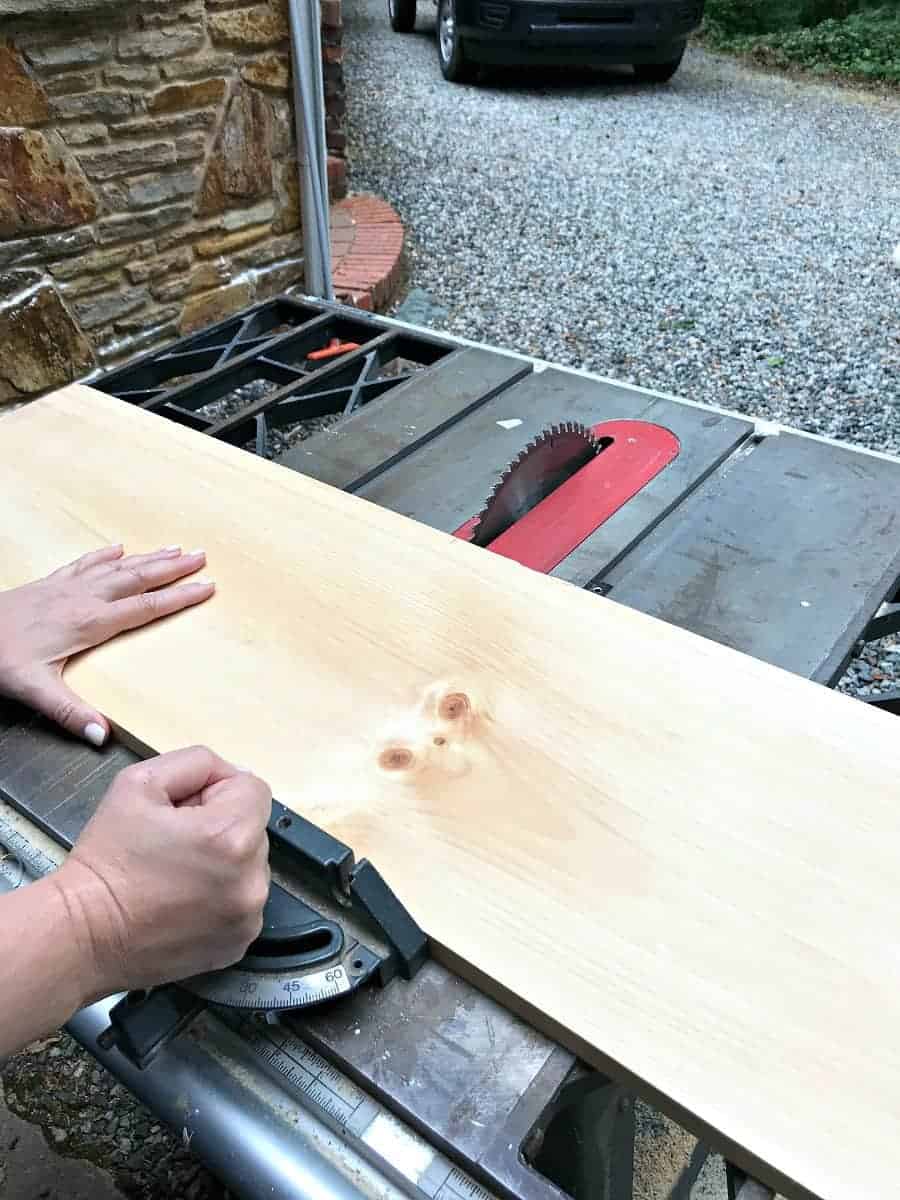 cutting 8' pine board on table saw for DIY wood planter