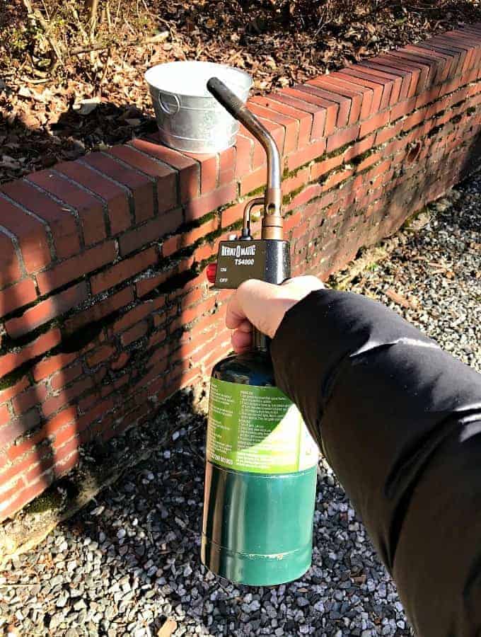 propane torch used to age galvanized bucket for a DIY succulent planter