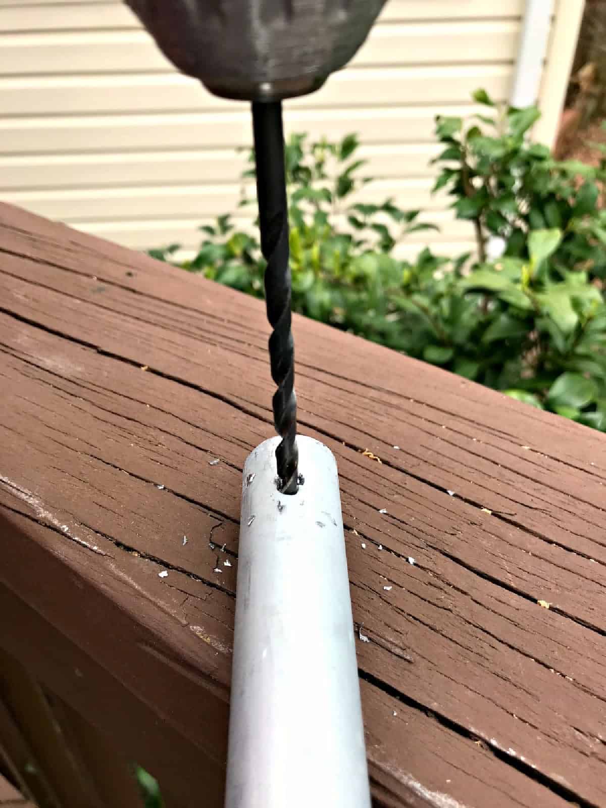 DIY Bird Feeder Pole drilling hole in pipe for bird feeder