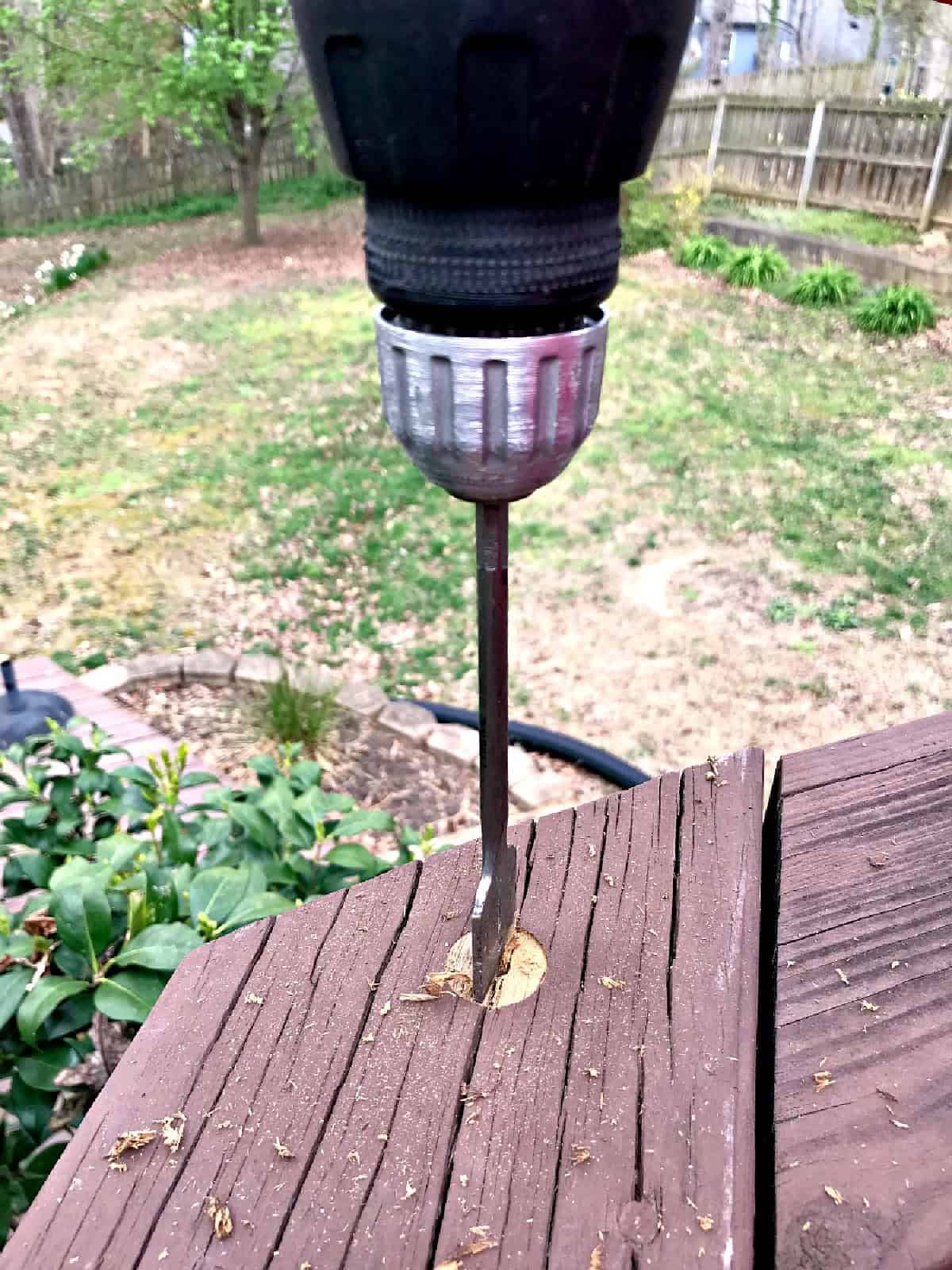 DIY Bird Feeder Pole drilling hole in deck rail with drill