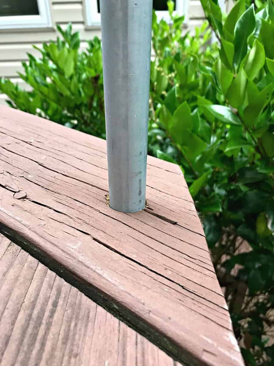 pipe in hole in deck rail for DIY bird feeder pole