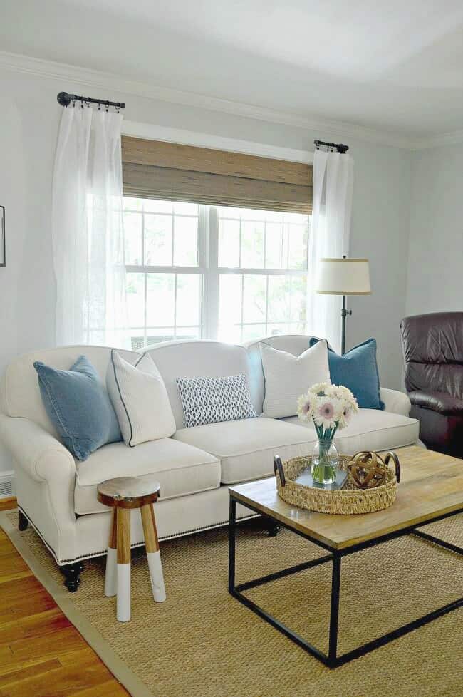 white living room sofa in front of big window