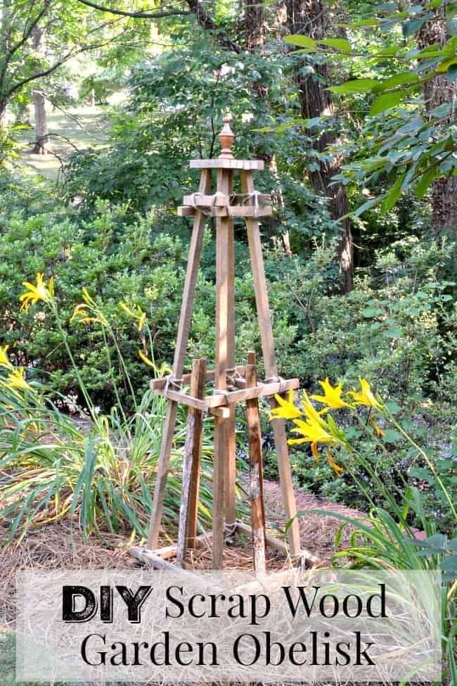 a DIY wooden garden obelisk in a garden with orange daylilies 