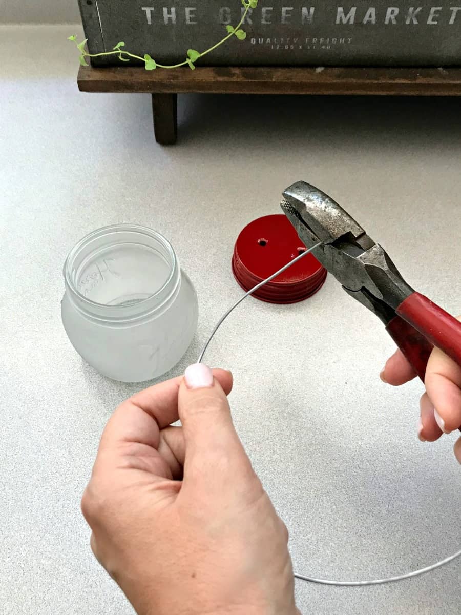 making DIY mason jar lanterns, cutting wire for lid