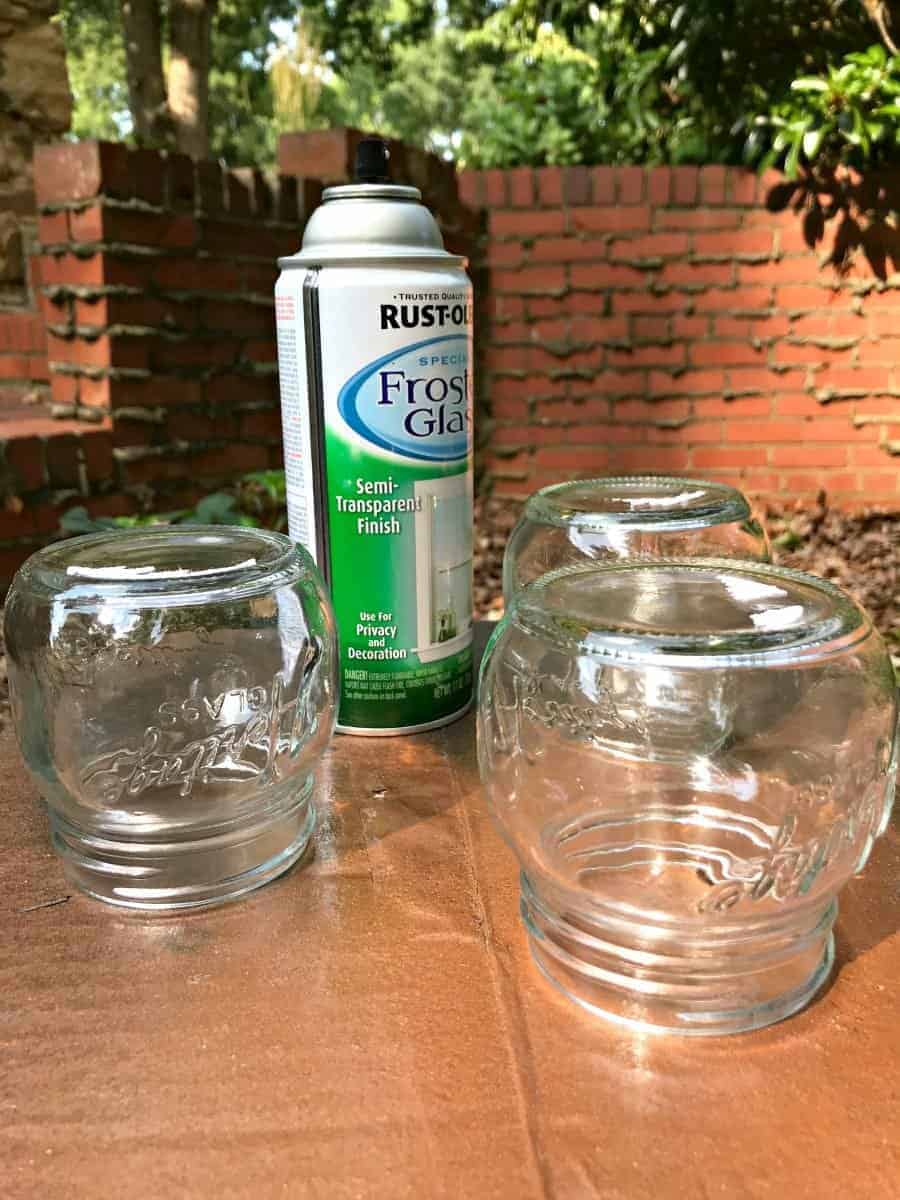 making DIY mason jar lanterns, spray paint and mason jars