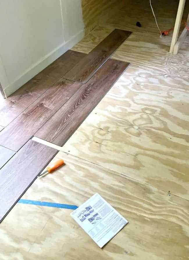 vinyl plank flooring laid out on plywood floor