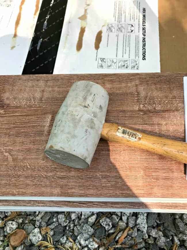 rubber mallet sitting on vinyl planks