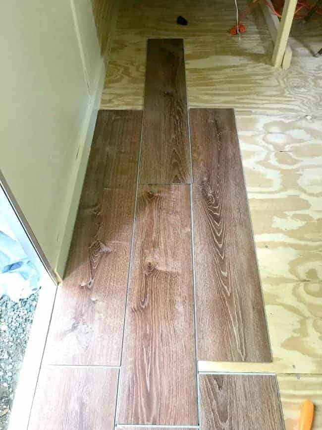 vinyl plank flooring laid out on plywood floor