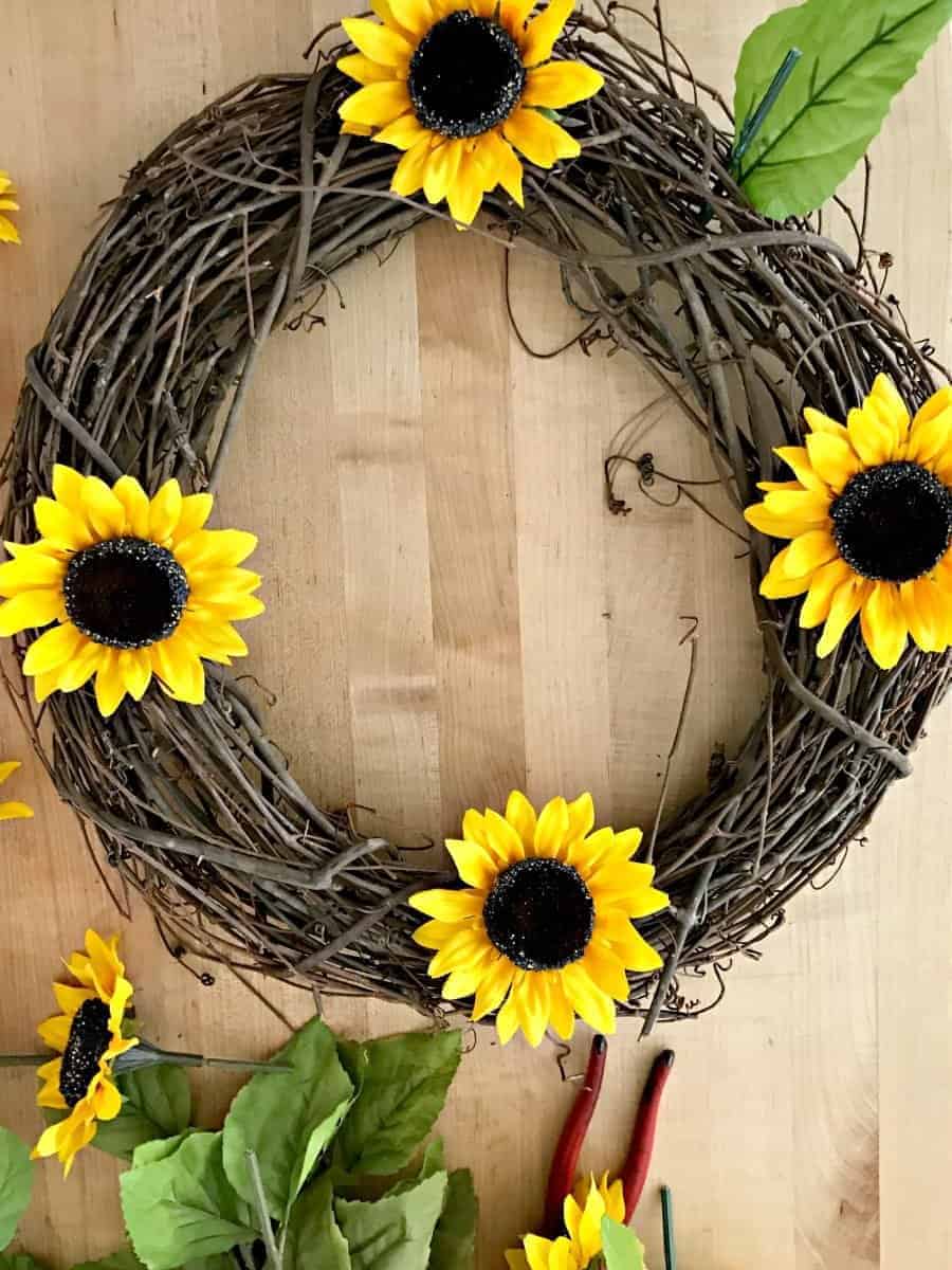 assembling wreath with sunflowers for a how to make a sunflower wreath tutorial