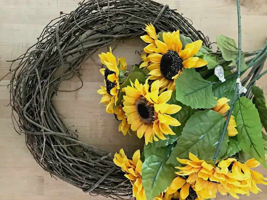 craft supplies of sunflowers and grapevine wreath for a How to Make a Sunflower Wreath tutorial