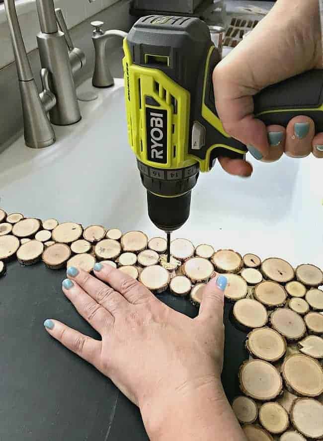 drilling hole in rustic wood slice chalkboard to add cording