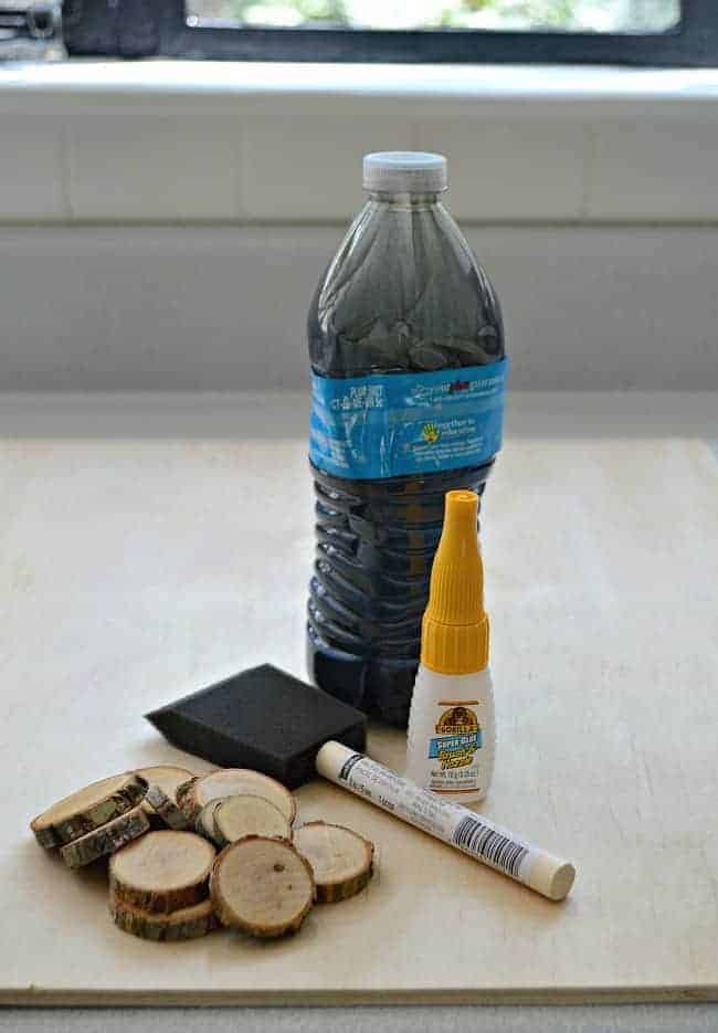 chalkboard paint, foam brush, wood rounds and Gorilla Glue used to make a rustic wood slice chalkboard