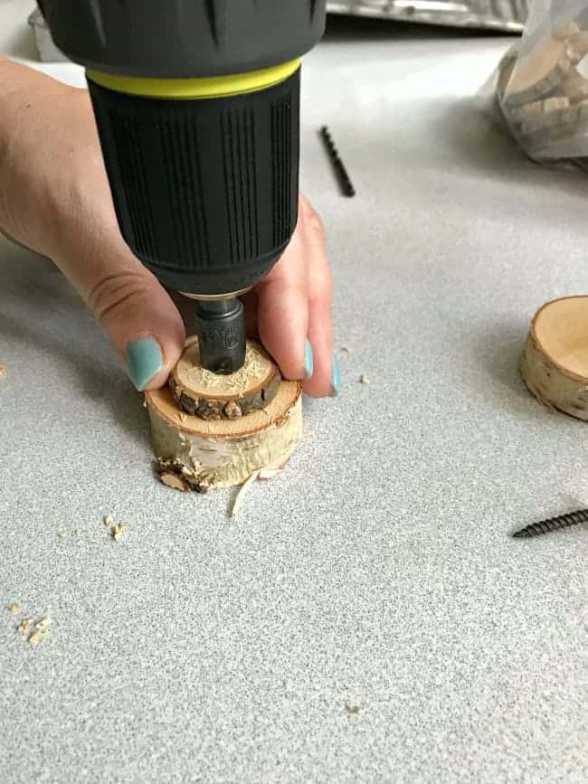 using drill to countersink hole in wood round while making a rustic wood slice chalkboard