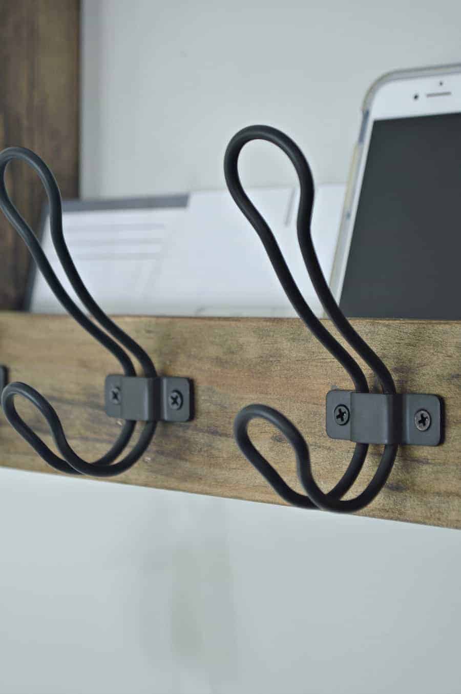 close up of black metal hooks on coat rack