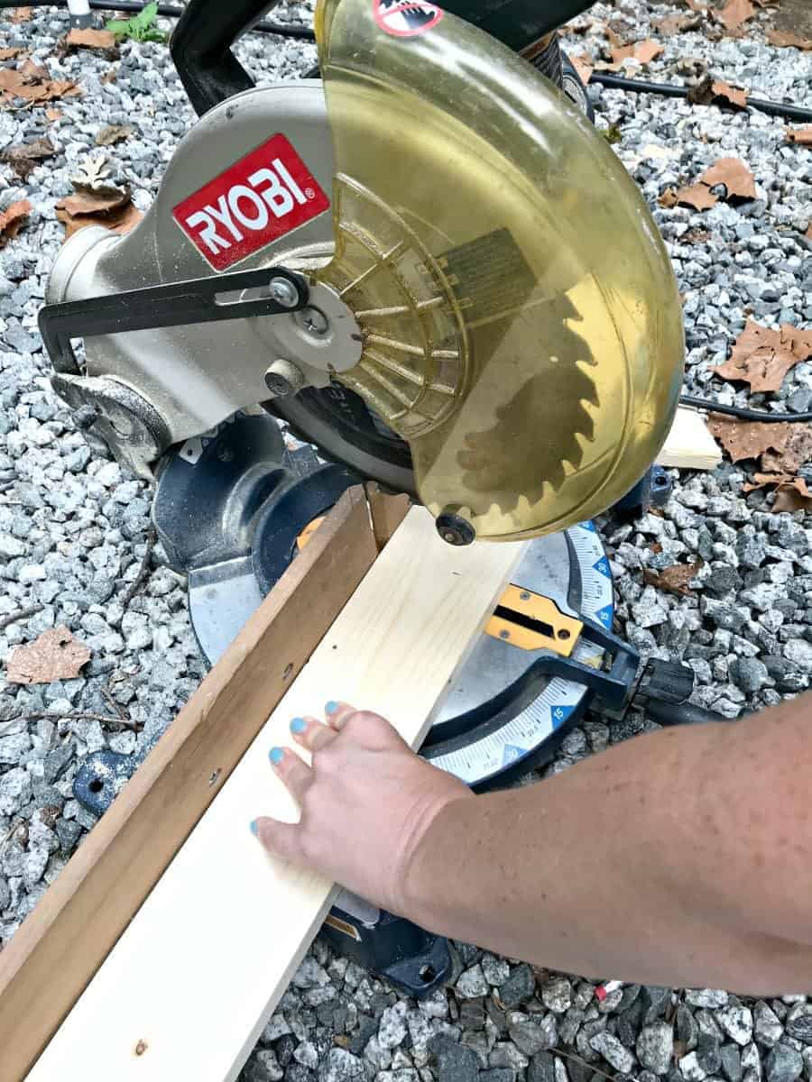 cutting wood on chop saw to make a wall mounted coat rack