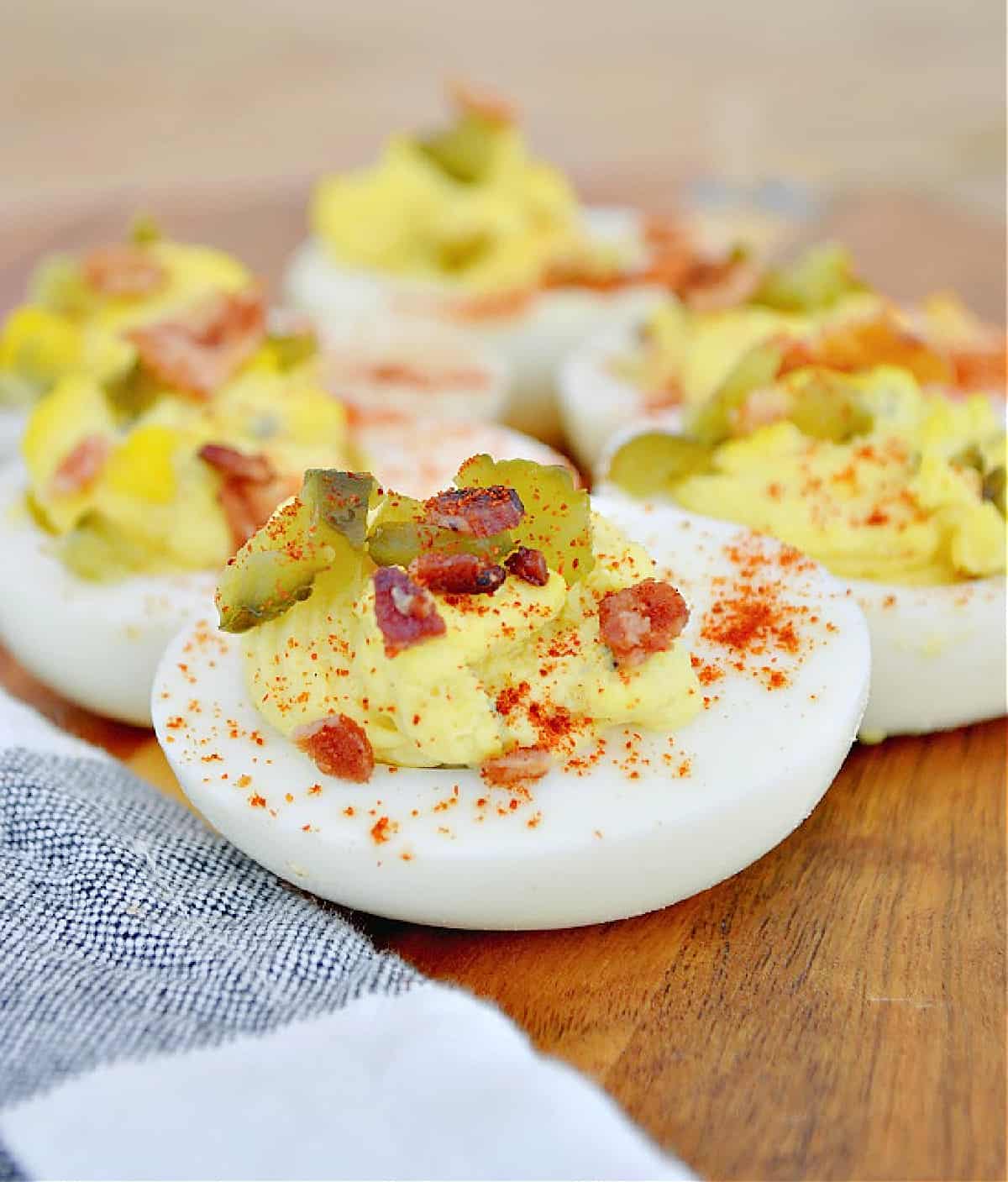 best ever deviled eggs on a cutting board with a dishtowel