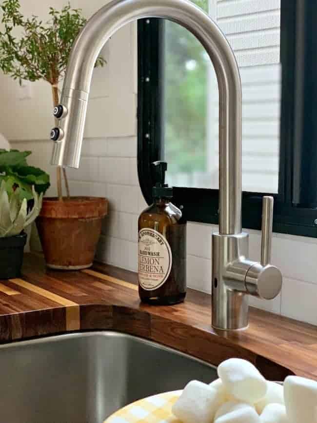 new kitchen faucet and bottle of hand soap for RV remodel update