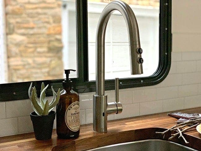new kitchen faucet, succulent and bottle of hand soap for RV remodel update
