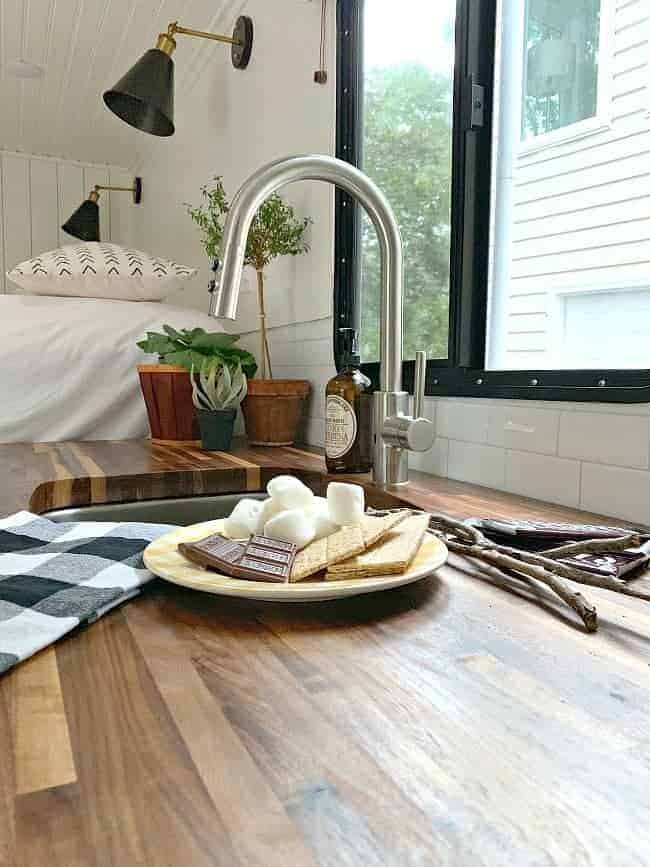 s'more toppings on a plate on butcher block countertop and new faucet for an RV remodel update