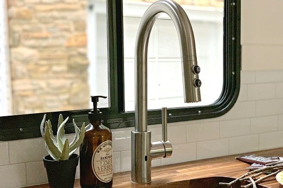 A close up of a sink and a window in a cargo trailer