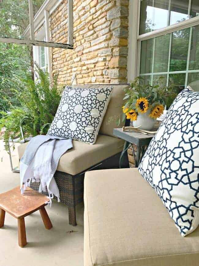 front porch fall decor with wicker chairs and blue and white pillows