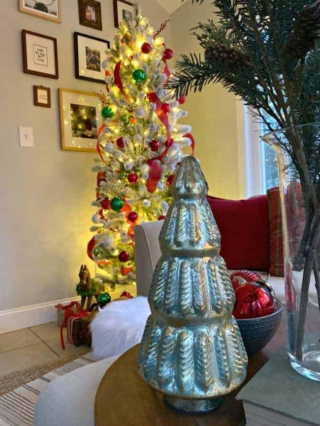 A Cozy Christmas Cottage with a red and green flocked tree plus a green mercury glass tree