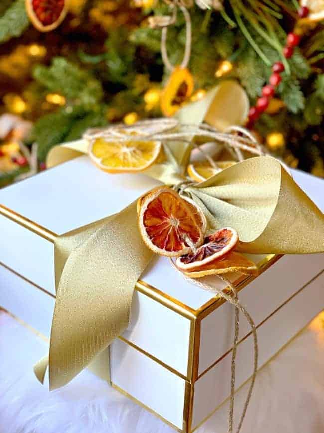 dried orange slice banner on white wrapped gift box