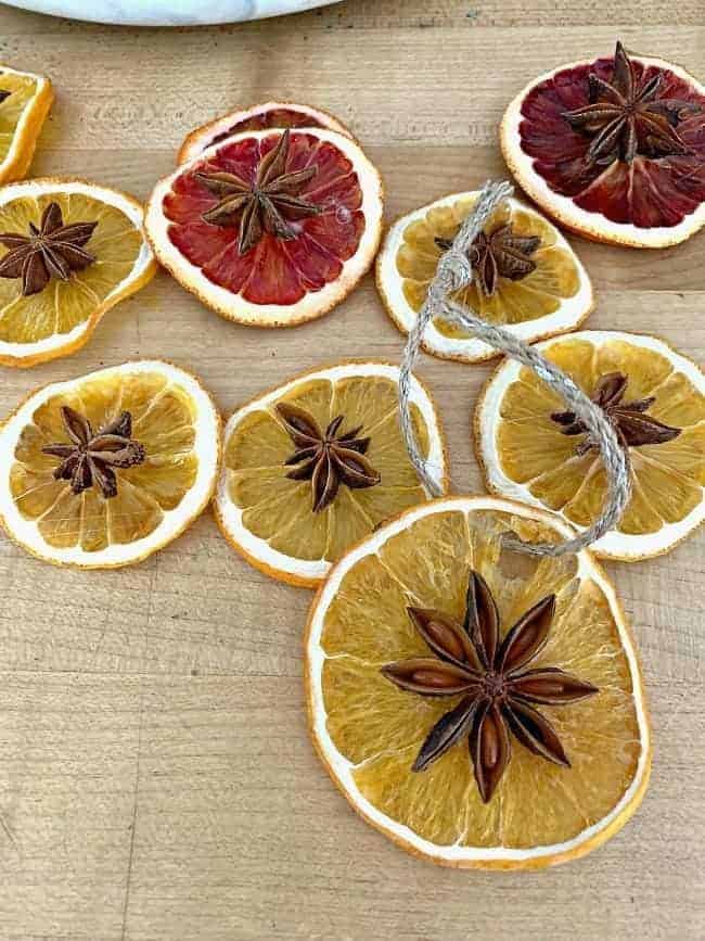 dried orange slice ornaments with star anise on cutting board