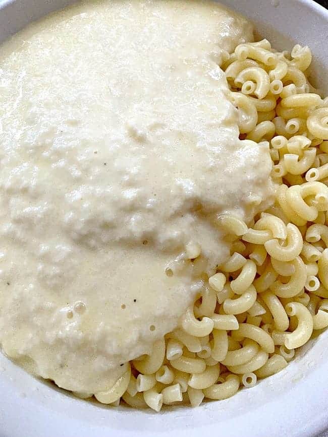 melted cheese and milk on cooked elbow noodles