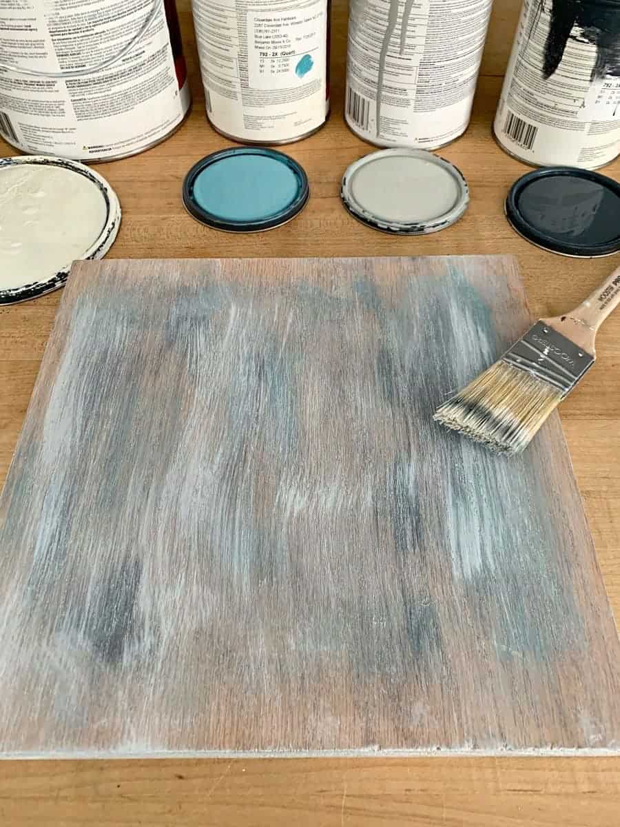 drybrushing paint on piece of oak with paintbrush