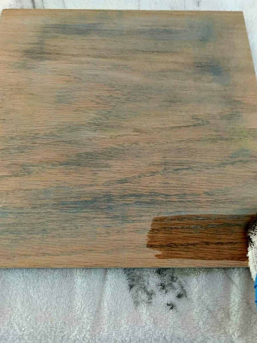 applying wood stain to piece of oak wood