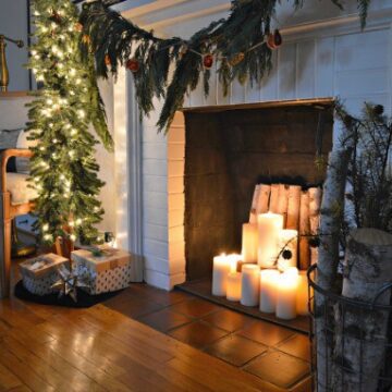 A living room decorated for Christmas and a fire place