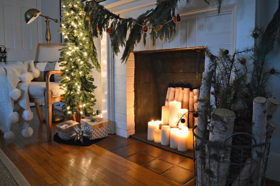 A living room decorated for Christmas and a fire place