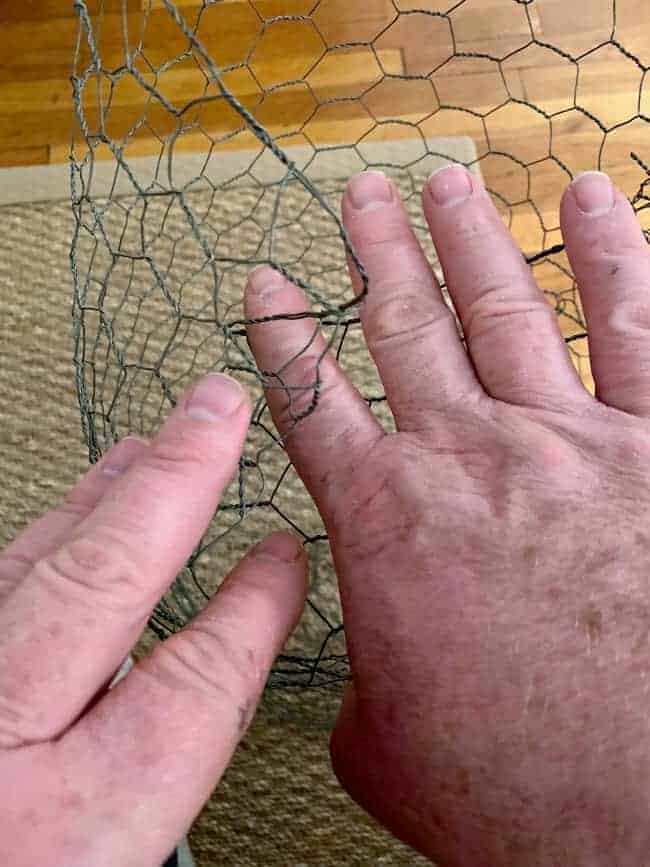 folding in end of chicken wire to create DIY lighted chicken wire Christmas balls