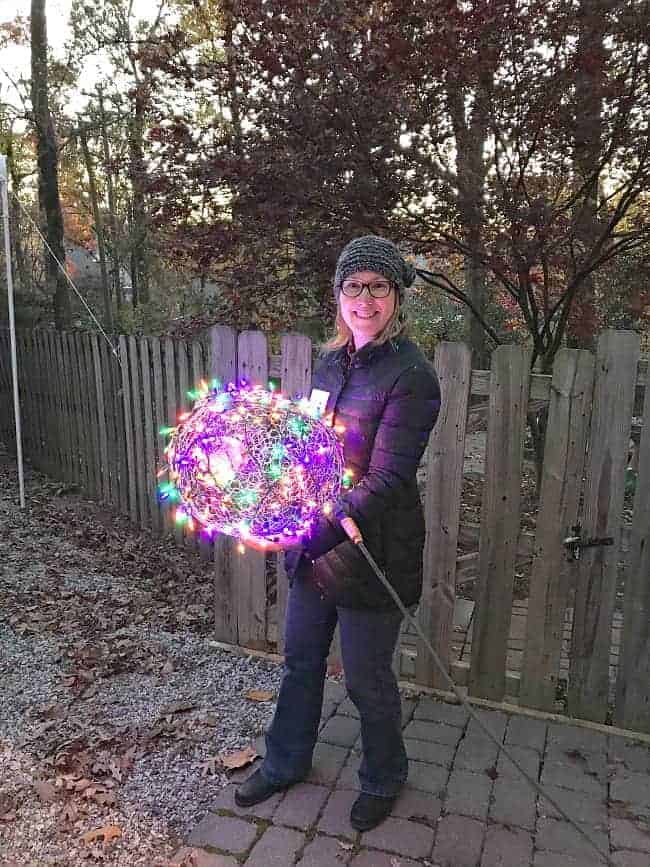 woman holding DIY Lighted Chicken Wire Christmas Ball