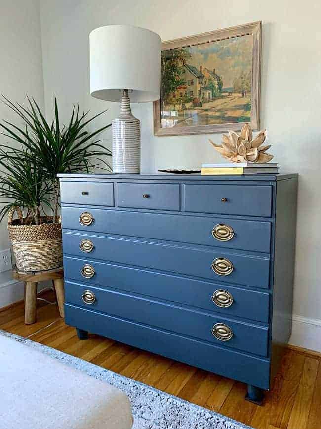 navy blue painted dresser with painting hanging over it for guest bedroom makeover