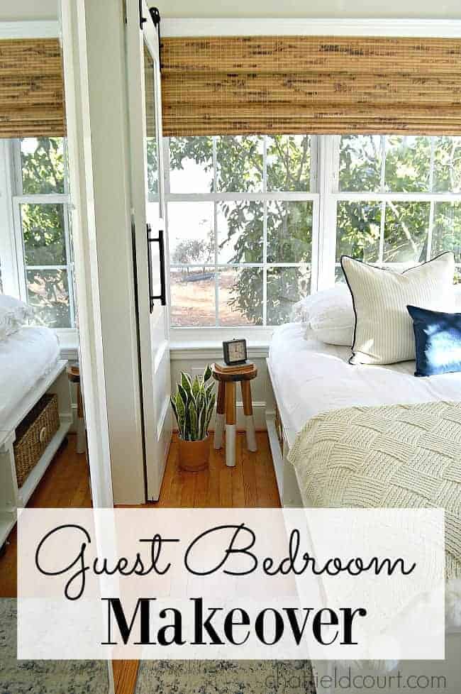 view of guest bedroom window, woven shades and side of bed with a stool for a side table